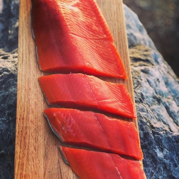 cuts of salmon filet on cutting board