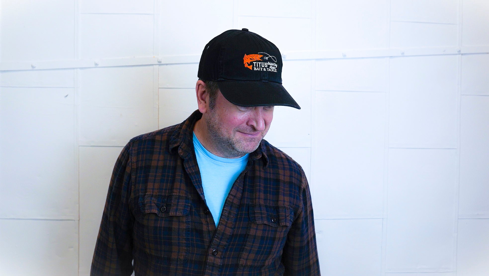 man wearing Titus bait and tackle hat